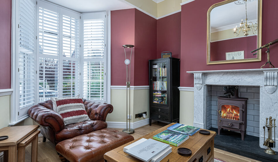 Cozy living room with leather sofa, fireplace, elegant decor by UK property photographer, North Wales photographer.