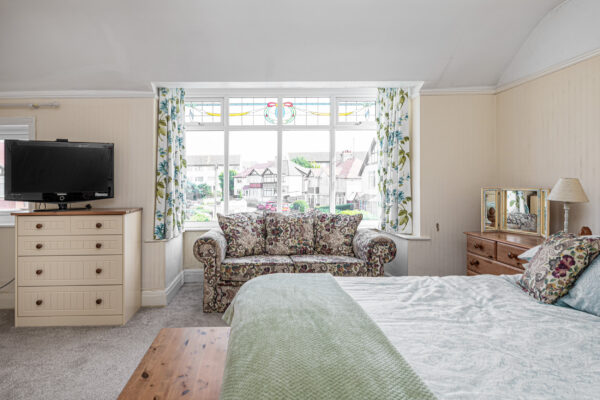 Cosy bedroom interior with large window view, captured by UK property photographer, North Wales photographer.