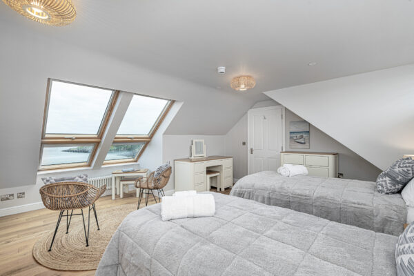 Luxurious UK bedroom with sea view by a North Wales property photographer. Elegant and inviting interior design.