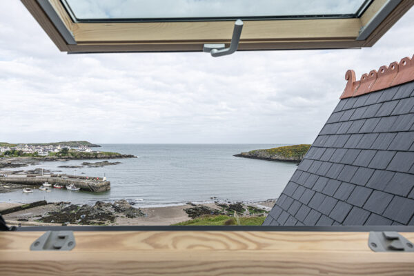 Stunning coastal view from a window, captured by a UK property photographer in North Wales. Idyllic and serene scenery.