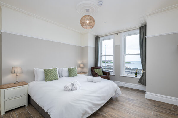 Modern bedroom interior with sea view captured by UK property photographer in North Wales.