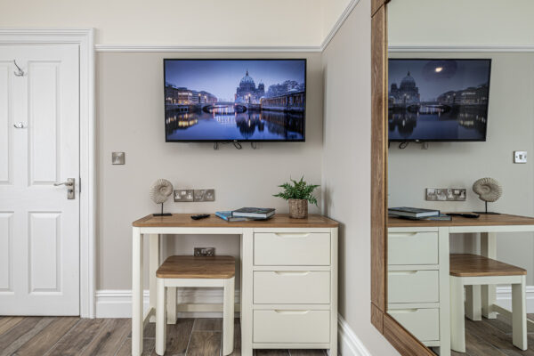Stylish interior captured by UK property photographer, featuring a TV and desk. Image by North Wales photographer.
