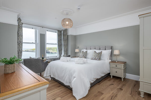Luxury bedroom with sea view, captured by a UK property photographer in North Wales. Crisp, elegant, and inviting.