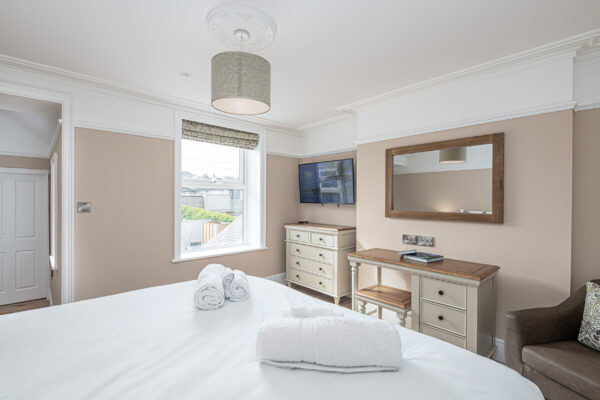 Luxurious bedroom interior, captured by UK property photographer in North Wales. Modern decor and natural light.