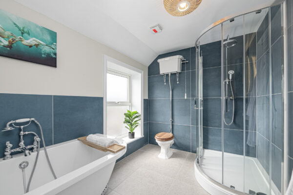 Modern bathroom interior by UK property photographer, featuring shower and freestanding tub, North Wales photographer.