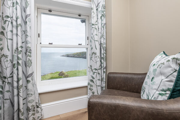 Elegant coastal view from a window, captured by UK property photographer in North Wales.
