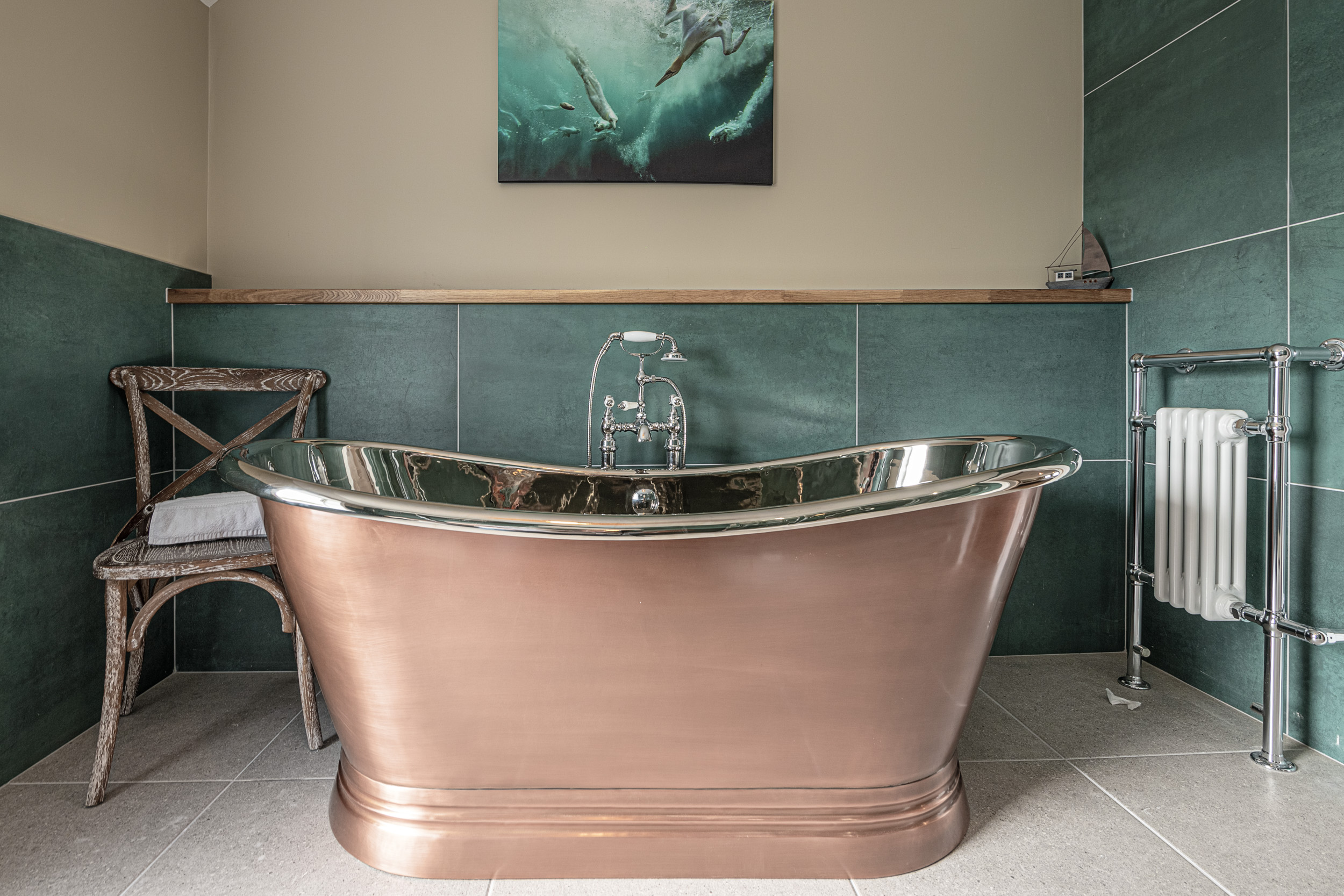Copper bathtub in elegant bathroom, captured by UK property photographer in North Wales.