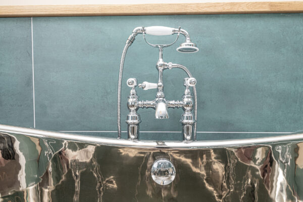 Elegant bathroom design by UK property photographer in North Wales, showcasing a stylish chrome bath faucet.