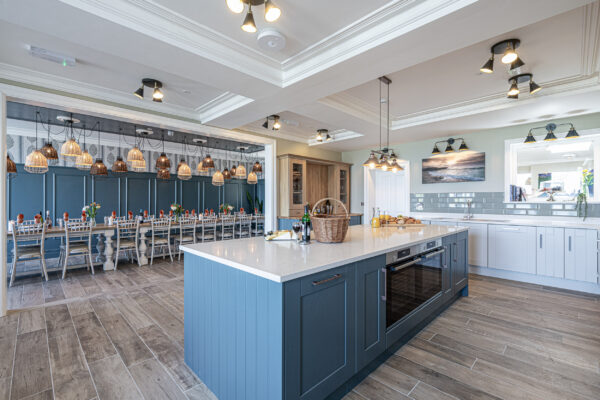 Modern kitchen and dining area captured by UK property photographer, North Wales photographer, featuring elegant lighting.