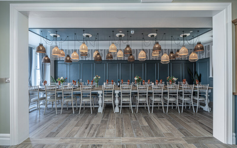 Dining area captured by UK property photographer, North Wales. Elegant table setup with modern lighting.