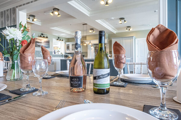 Dining setup with wine in a stylish kitchen by UK property photographer, North Wales photographer.