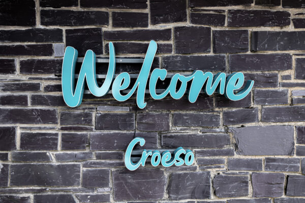 Welcome sign on brick wall, UK property photographer, North Wales photographer, Croeso in turquoise lettering.