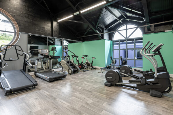 Modern gym interior captured by UK property photographer, North Wales photographer. Featuring exercise equipment.