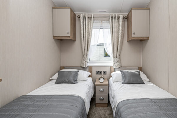 Two twin beds in a modern home captured by a UK property photographer, showcasing interior design in North Wales.
