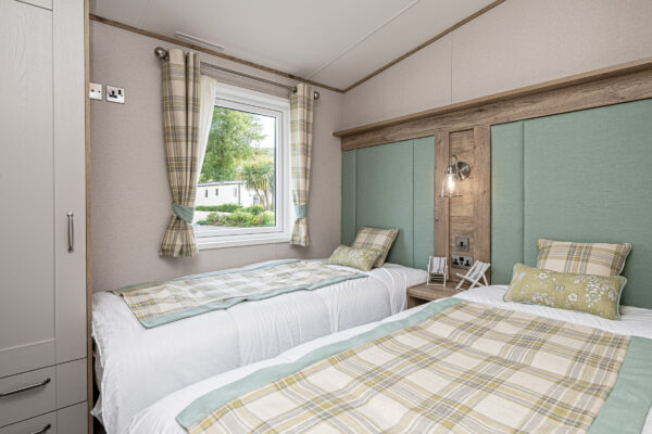 alt text: Bright twin bedroom in UK, captured by North Wales property photographer, showcasing elegant decor and natural light.