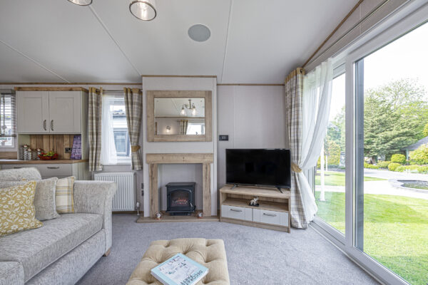Modern living room interior captured by UK property photographer in North Wales. Cozy and bright with garden view.