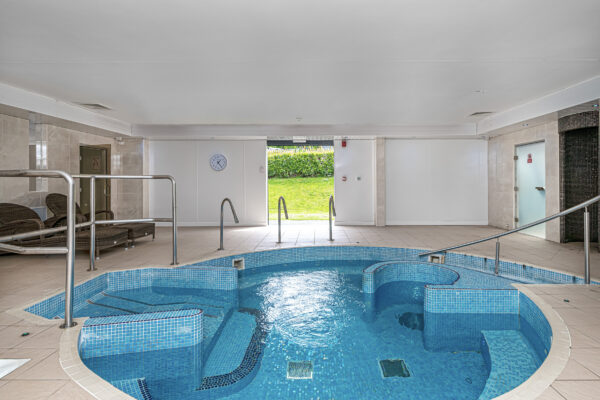 Indoor pool shot by UK property photographer, showcasing luxury amenities. North Wales photographer captures serene setting.