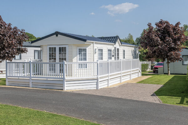 Modern mobile home on a sunlit site, captured by a UK property photographer in North Wales.