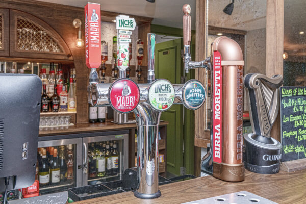 Alt text: UK property photographer captures vibrant bar taps in North Wales pub setting.