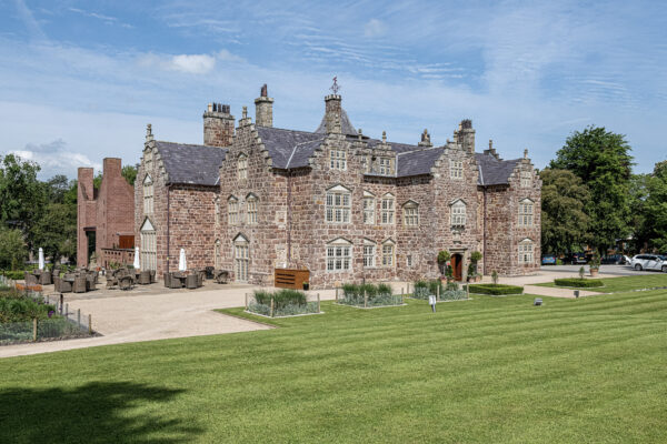 Historic mansion in North Wales captured by UK property photographer, showcasing stunning architecture and lush greenery.