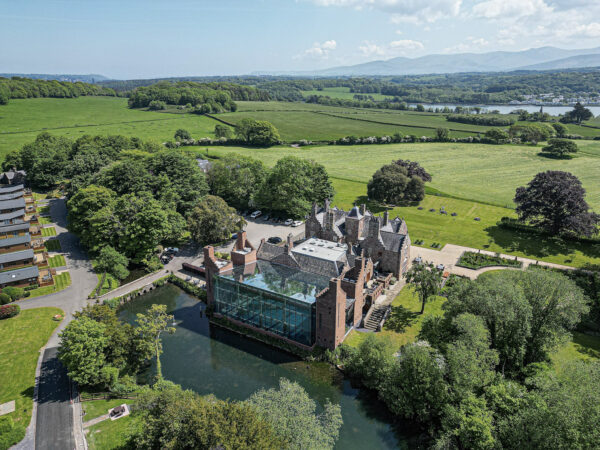 Aerial shot of a historic mansion in lush North Wales landscape by UK property photographer, ideal for real estate showcase.