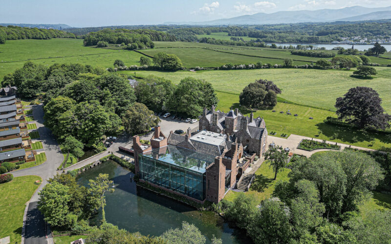 Aerial shot of a historic mansion in lush North Wales landscape by UK property photographer, ideal for real estate showcase.