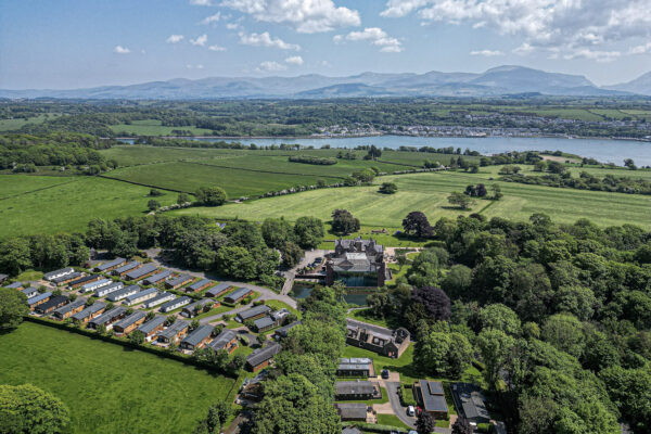 Aerial view of lush countryside in North Wales captured by UK property photographer, showcasing scenic landscapes and homes.