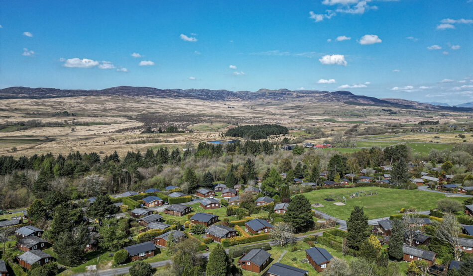 Aerial view of cabins in lush landscape by UK property photographer. Scenic North Wales captured by expert photographer.