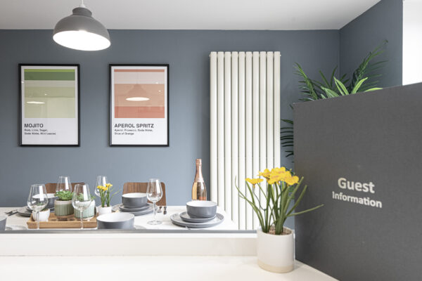 Dining area captured by UK property photographer, North Wales. Elegant table setup with decor and wall art.